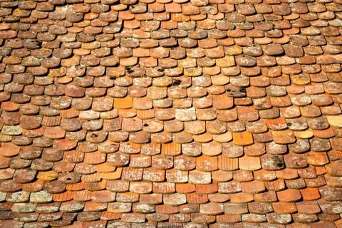 Abstract pattern of old, traditional, brown/orange, ceramic, overlapping shingle Stock Photos