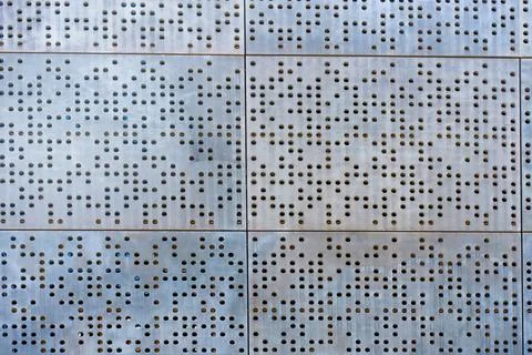 Abstract Pattern Of Perforated Metal Wall Design Stock Photos