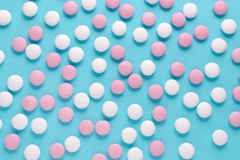 Abstract pattern of pink and white candy on blue background Stock Photos