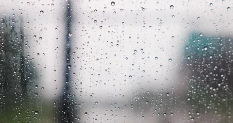 Abstract pattern of rain drops on car window glass with blurred city traffi.. Stock Footage 322557997