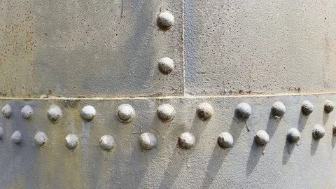 Abstract Pattern of Rivets Across an Old Steel Panel Stock Footage 339378241