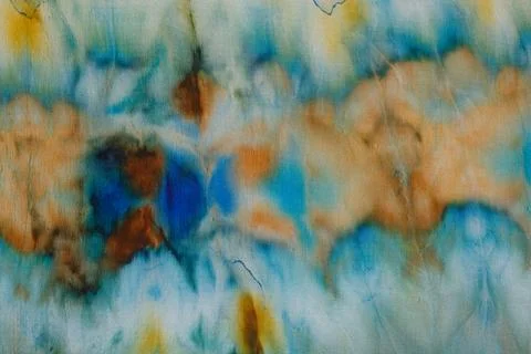 Abstract pattern on silk fabric texture in blue, yellow, green colors Illustrazione stock