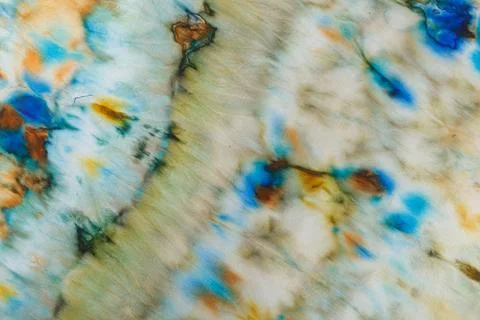 Abstract pattern on silk fabric texture in blue, yellow, green colors Stock Photos