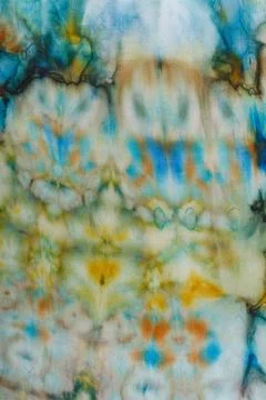 Abstract pattern on silk fabric texture in blue, yellow, green colors Stock Photos