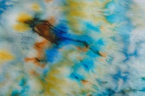 Abstract pattern on silk fabric texture in blue, yellow, green colors Stock Photos