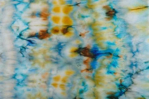 Abstract pattern on silk fabric texture in blue, yellow, green colors Stock Photos