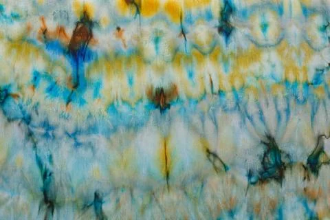 Abstract pattern on silk fabric texture in blue, yellow, green colors Stock Photos