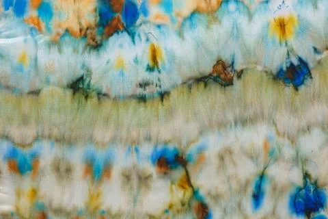 Abstract pattern on silk fabric texture in blue, yellow, green colors Stock Photos