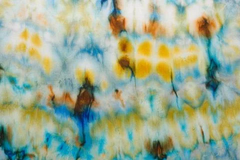 Abstract pattern on silk fabric texture in blue, yellow, green colors Stock Photos