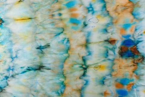 Abstract pattern on silk fabric texture in blue, yellow, green colors Stock Photos