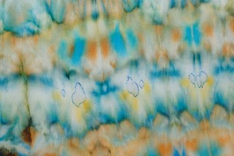 Abstract pattern on silk fabric texture in blue, yellow, green colors Stock Photos