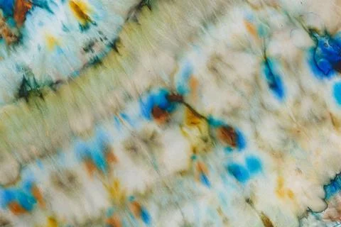 Abstract pattern on silk fabric texture in blue, yellow, green colors Stock Photos