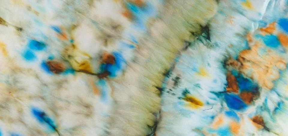 Abstract pattern on silk fabric texture in blue, yellow, green colors Stock Photos