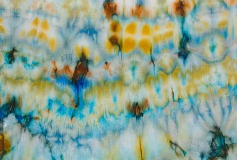 Abstract pattern on silk fabric texture in blue, yellow, green colors Stock Photos