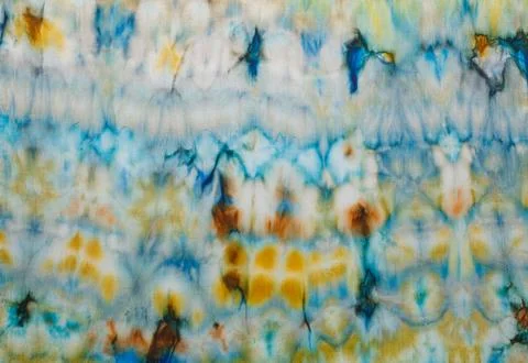 Abstract pattern on silk fabric texture in blue, yellow, green colors Stock Photos