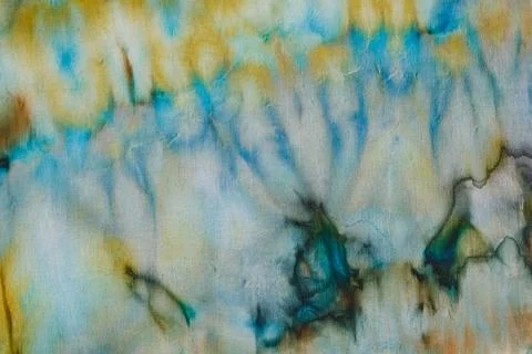 Abstract pattern on silk fabric texture in blue, yellow, green colors Stock Photos
