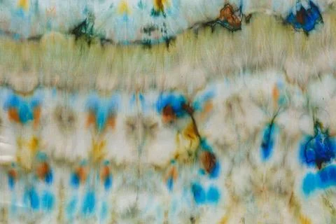 Abstract pattern on silk fabric texture in blue, yellow, green colors Stock Photos