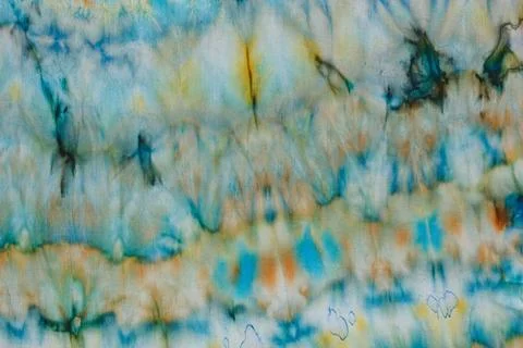 Abstract pattern on silk fabric texture in blue, yellow, green colors Stock Photos