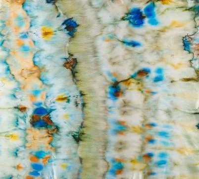 Abstract pattern on silk fabric texture in blue, yellow, green colors Stock Photos