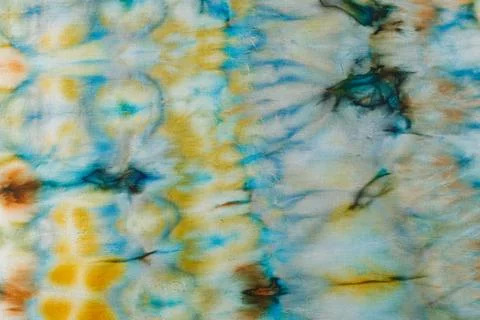 Abstract pattern on silk fabric texture in blue, yellow, green colors Stock Photos