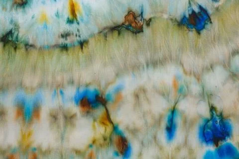 Abstract pattern on silk fabric texture in blue, yellow, green colors Stock Photos