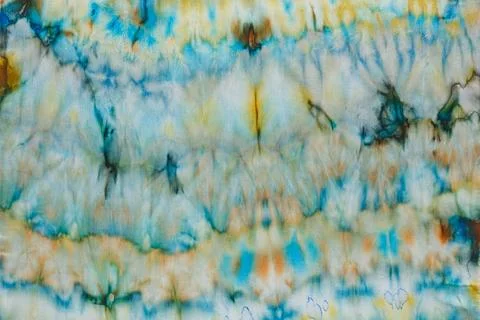 Abstract pattern on silk fabric texture in blue, yellow, green colors Foto stock