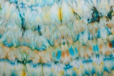 Abstract pattern on silk fabric texture in blue, yellow, green colors Foto stock