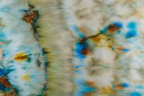 Abstract pattern on silk fabric texture in blue, yellow, green colors Foto stock