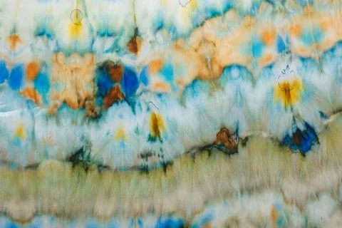 Abstract pattern on silk fabric texture in blue, yellow, green colors Stock Photos