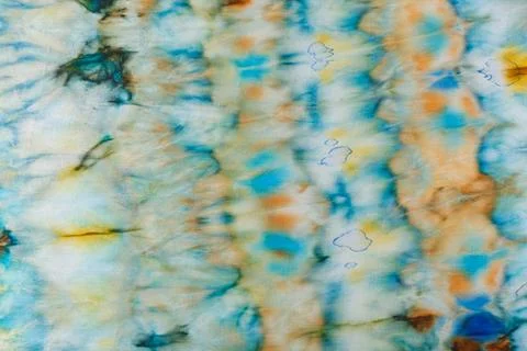 Abstract pattern on silk fabric texture in blue, yellow, green colors Stock Photos
