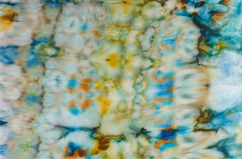 Abstract pattern on silk fabric texture in blue, yellow, green colors Stock Photos