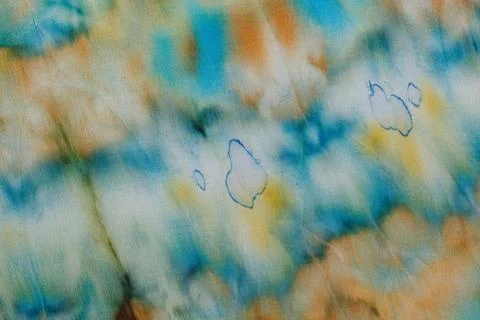 Abstract pattern on silk fabric texture in blue, yellow, green colors Stock Photos
