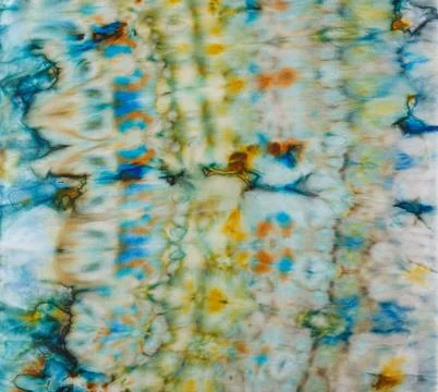 Abstract pattern on silk fabric texture in blue, yellow, green colors Stock Photos