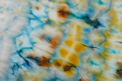 Abstract pattern on silk fabric texture in blue, yellow, green colors Stock Photos