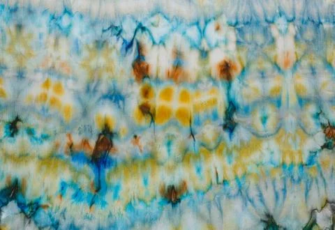 Abstract pattern on silk fabric texture in blue, yellow, green colors Stock Photos