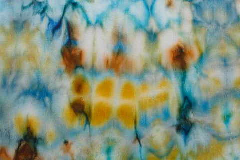 Abstract pattern on silk fabric texture in blue, yellow, green colors Stock Photos