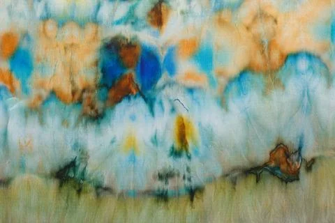 Abstract pattern on silk fabric texture in blue, yellow, green colors Stock Photos