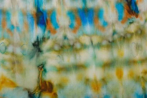 Abstract pattern on silk fabric texture in blue, yellow, green colors Stock Photos