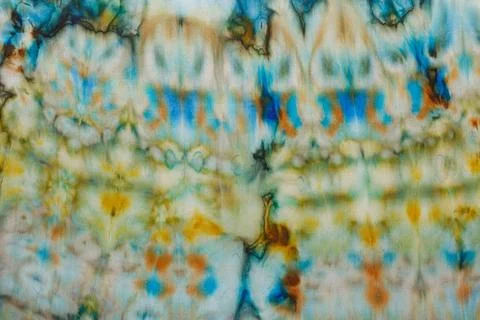 Abstract pattern on silk fabric texture in blue, yellow, green colors Stock Photos