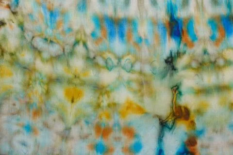 Abstract pattern on silk fabric texture in blue, yellow, green colors Stock Photos