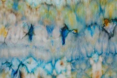 Abstract pattern on silk fabric texture in blue, yellow, green colors Stock Photos