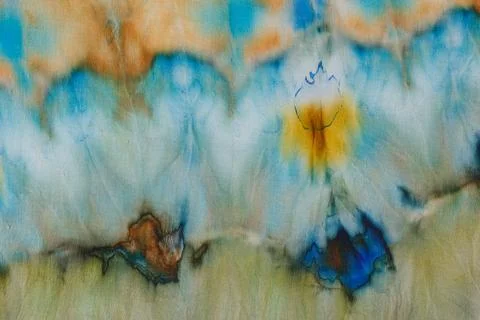 Abstract pattern on silk fabric texture in blue, yellow, green colors Stock Photos