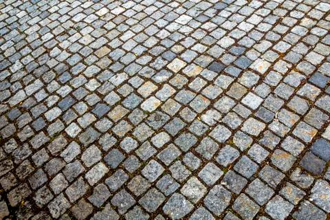 Abstract pattern of squared old-fashioned simple rough gray concrete street c Stock Photos