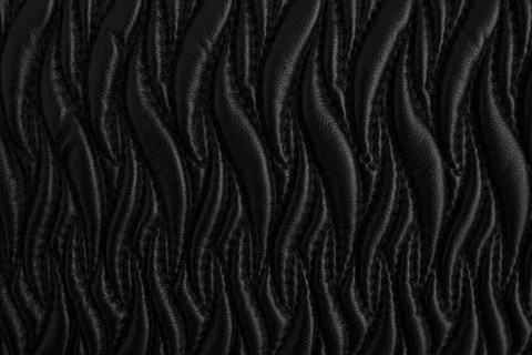Abstract pattern with stitches on black leather, ornamental flame  shapes o.. Stock Photos