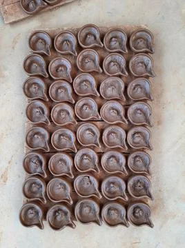 Abstract pattern texture background of wet handmade sand diya or oil lamps Stock Photos