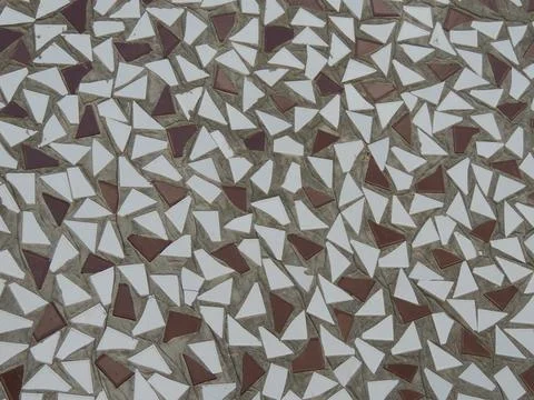 Abstract pattern of triangles of tiles on the wall Stockfoto's