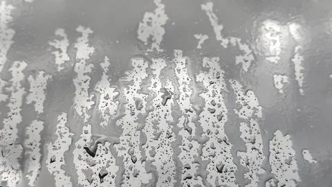 Abstract pattern of water droplets and streaks on a metallic surface Stock Photos