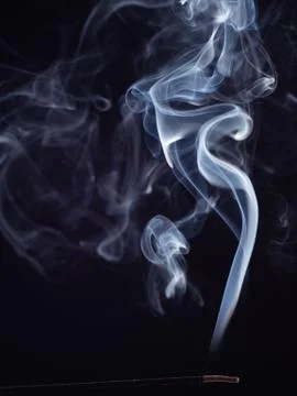 Abstract pattern of white smoke from burning incense, isolated on black Stock Photos