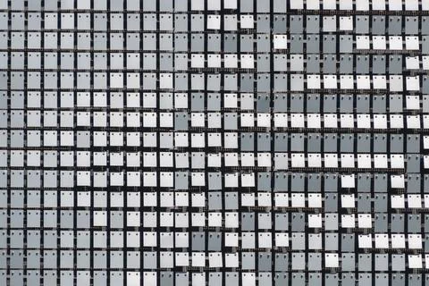 Abstract patterned wall with reflective square tiles in grayscale 스톡 사진
