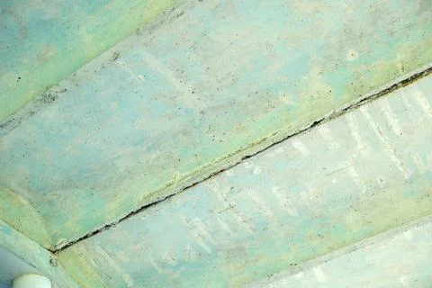 Abstract patterns emerge from a cracked ceiling in tranquil blue tones Stock Photos